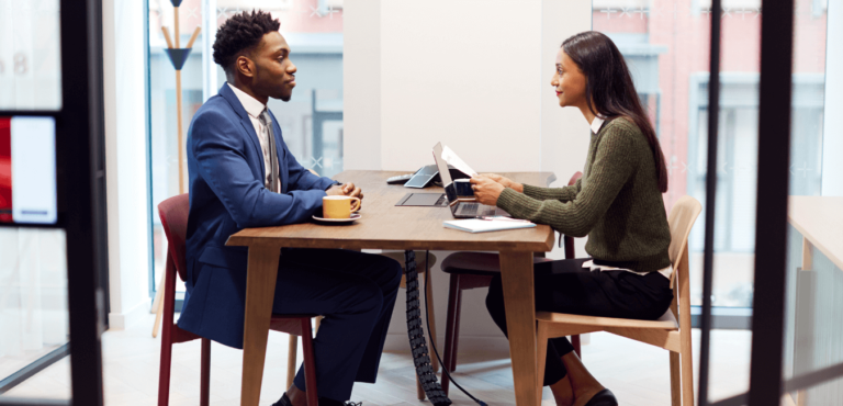 A black man is interviewed by a woman