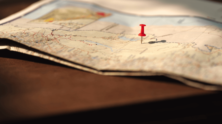 A red pin stuck into a roadmap similar to how we might consider career progression