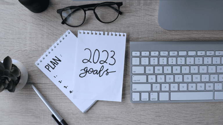 Computer keyboard and notepad with note about 2023 goals. This candidate is considering how job hunting will be different in 2023.