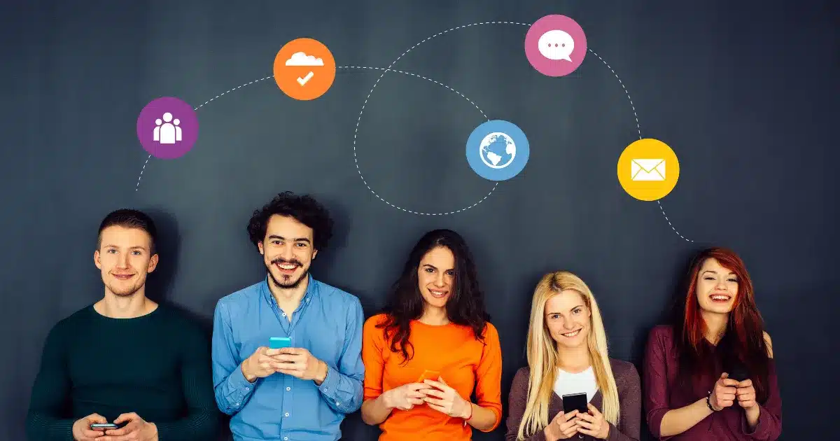 two men and three women smile while checking social media platforms on their phone