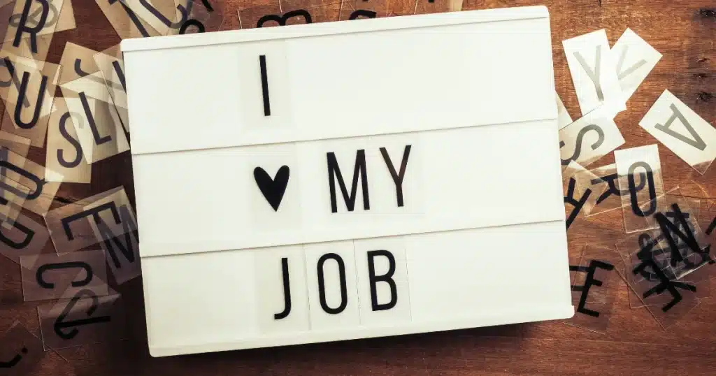 A happy employer has written down a message that says "I love my job"