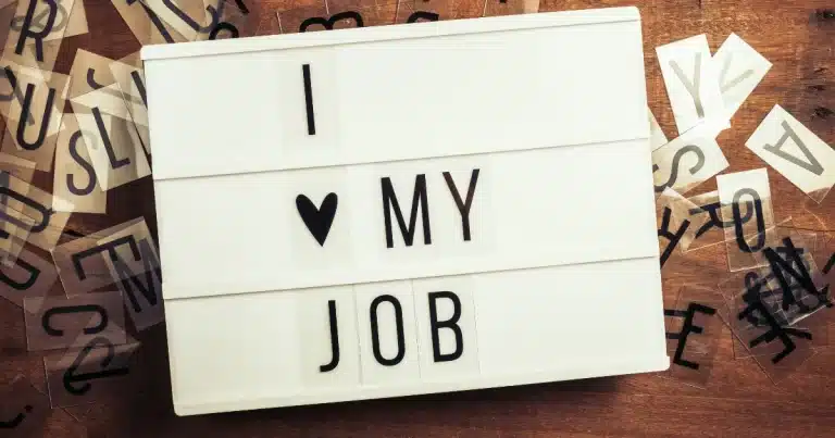 A happy employer has written down a message that says "I love my job"