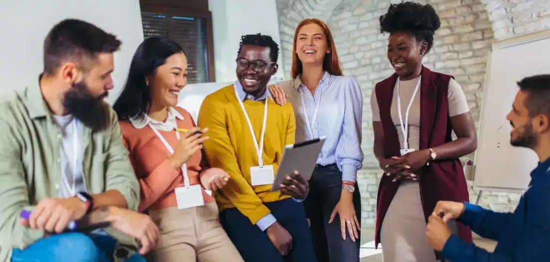 A diverse team of women and men chats friendly, happy to get involved in the company hiring process