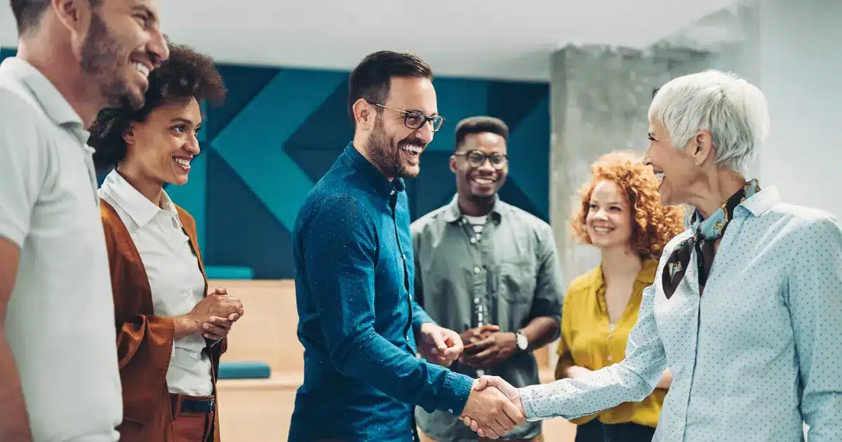 A new hire receives a warm welcome from his new colleagues