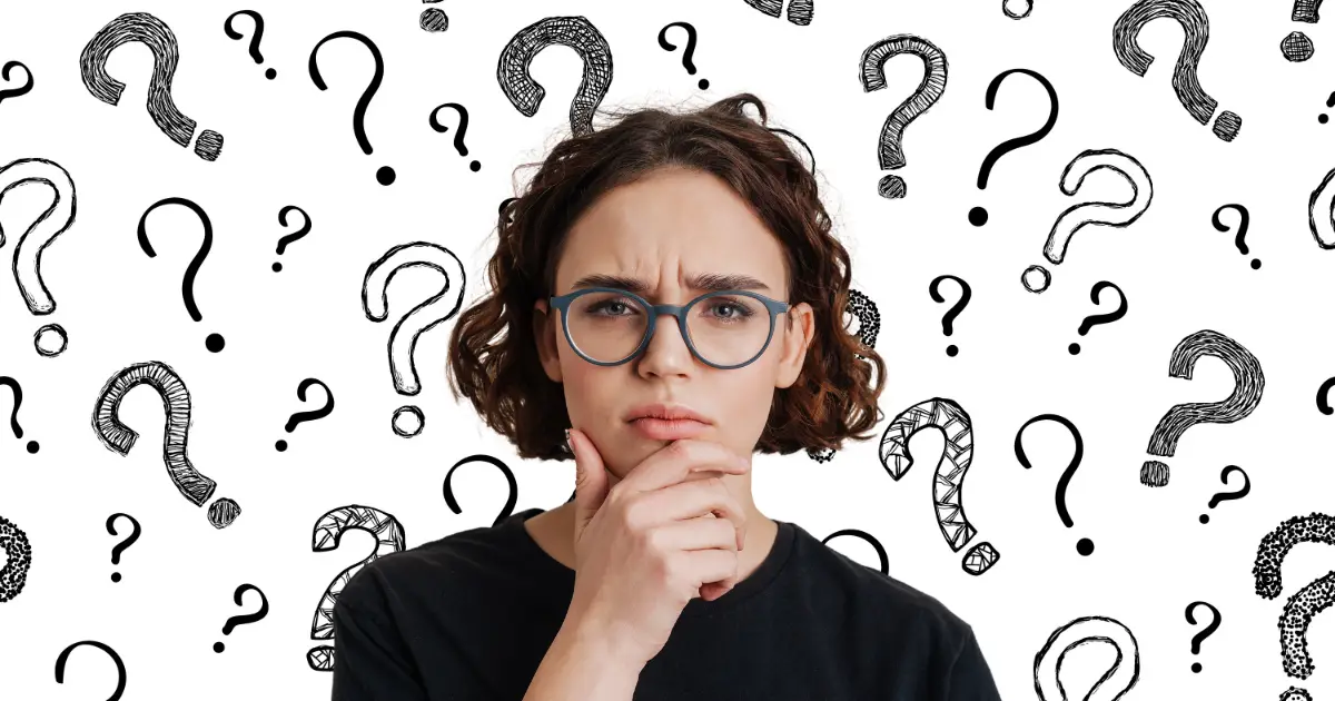 A young woman in glasses looks puzzled after her mind went blank in a job interview and she lost track of her words