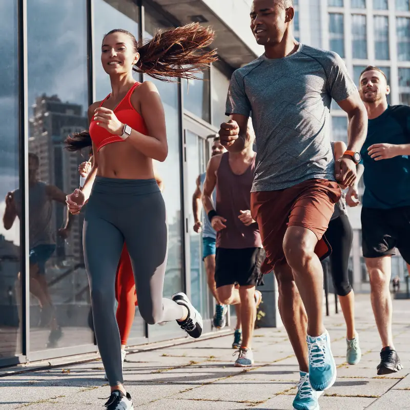 A group of people jogs in their lunch break in the streets of Manchester