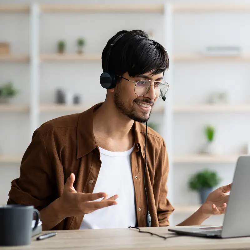 A young male professional replies confident to the hiring manager questions in a video interview