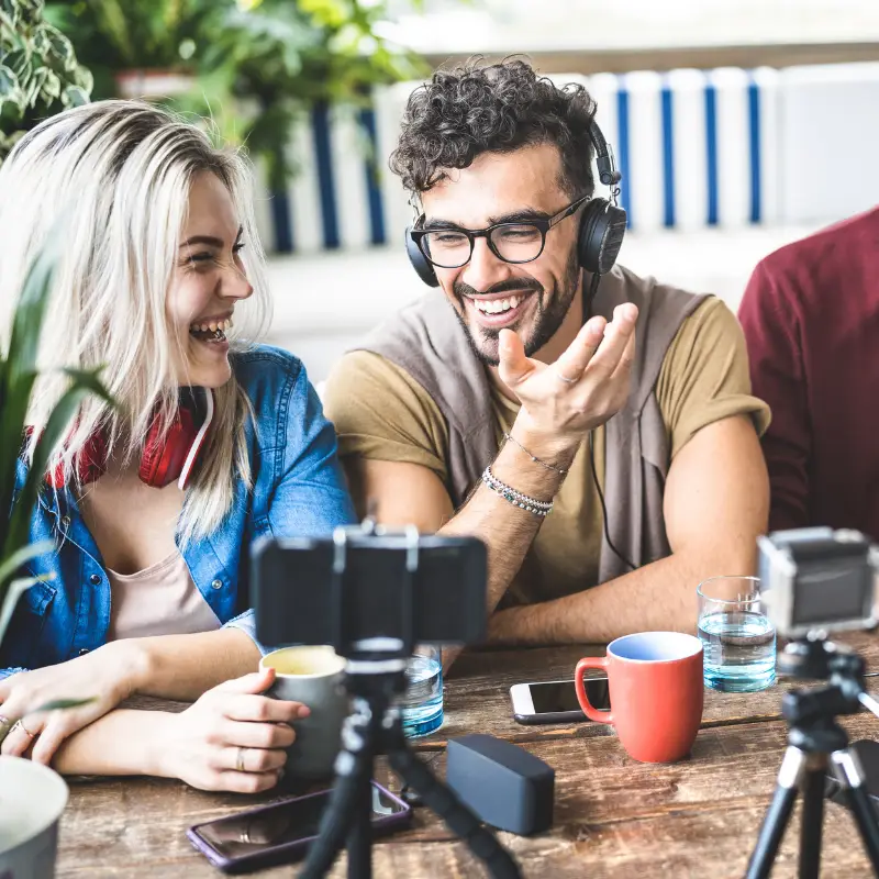 Two social media managers laugh recording content for a video