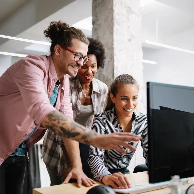 Two women and a man discuss a UX project before a presentation