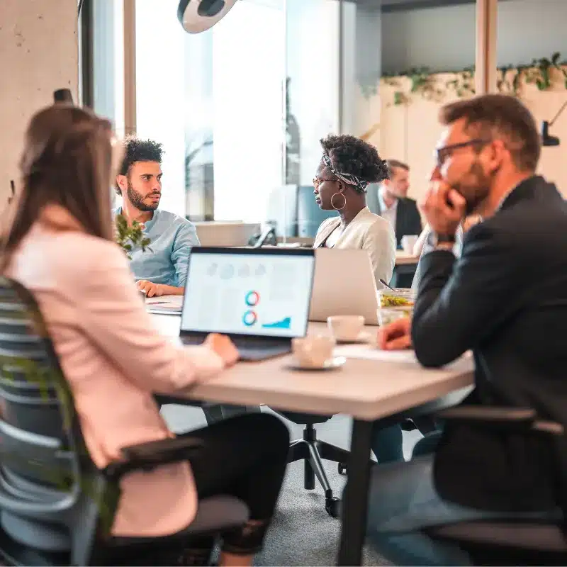 Different teams converse in a typical office for a digital agency in the UK