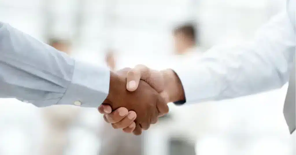 a hiring manager shake hands with a recruitment consultant