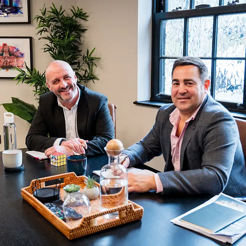 David and Nick sit in the office's boardroom, preparing a meeting with a new client