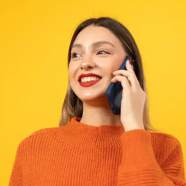 A young woman smiles while acing her pre screening interview with a recruiter